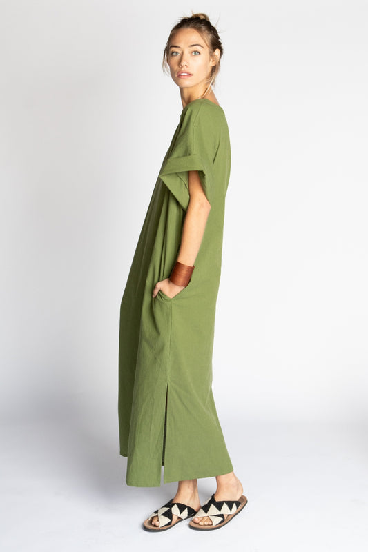 Model wearing long Moss green Ghost Tropic sustainable organic cotton Didion dress with kimono sleeves round neck pockets and side slits
