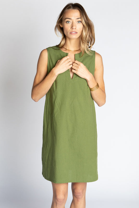 Model wearing Moss green Ghost Tropic sleeveless sustainable organic cotton Keaton mini dress with round neck and pockets