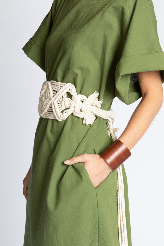 Model wearing long Moss green Ghost Tropic sustainable organic cotton Didion dress with kimono sleeves round neck pockets and side slits with long wide natural macrame Talisman obi belt with tassels