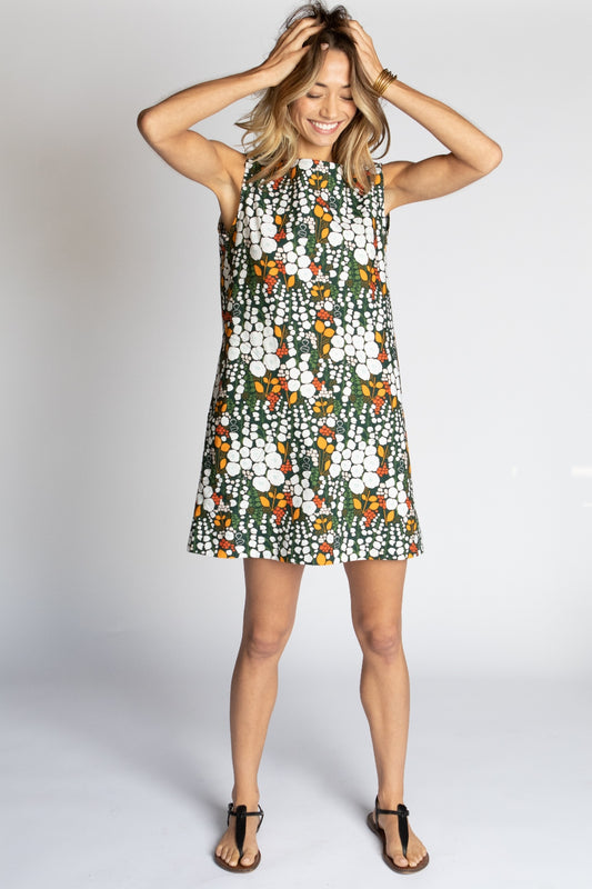 Model wearing Midnight Poppies multicolor black green yellow white floral Ghost Tropic sleeveless sustainable organic cotton Foster mini dress with round neck and pockets